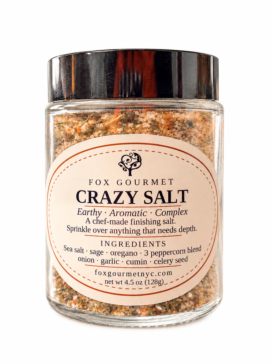 Fox Gourmet Crazy Salt in a glass jar, a chef-made finishing salt with sea salt, sage, oregano and three peppercorns