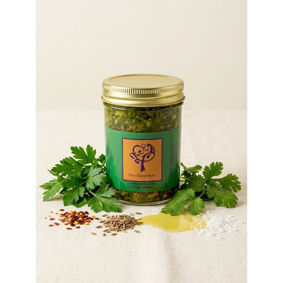 Fox Gourmet Chimichurri Sauce jar with fresh herbs
